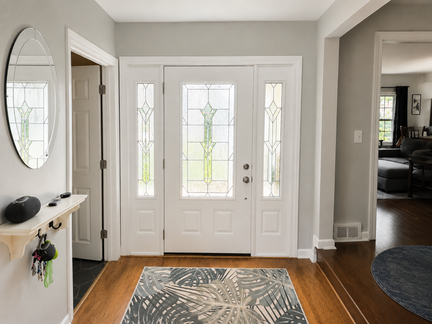Bright front entryway with freshly painted gray walls, white trim, and a clean white door